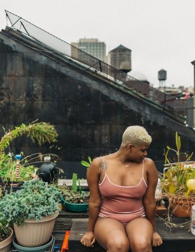 Ericka Hart on a rooftop surrounded by plants