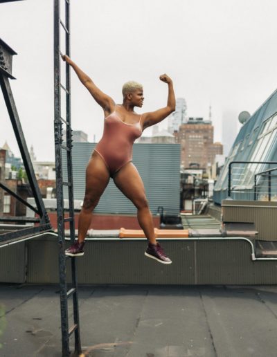 Ericka Hart on a ladder on a rooftop